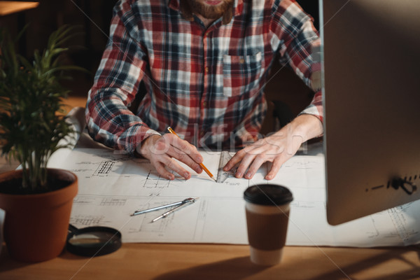 Close up portrait of man in shirt working with graph Stock photo © deandrobot