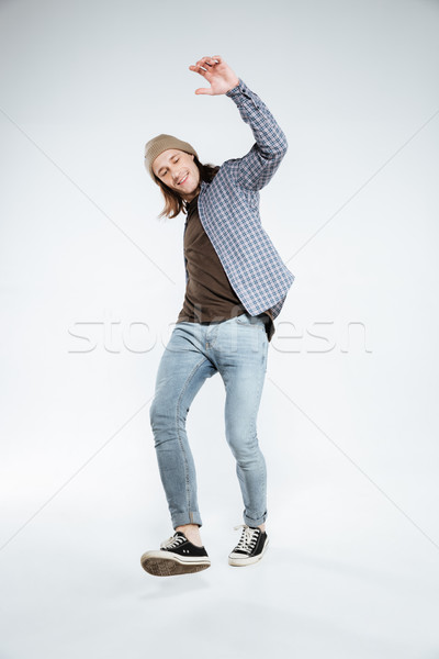 Vertical image of funny hipster in studio Stock photo © deandrobot