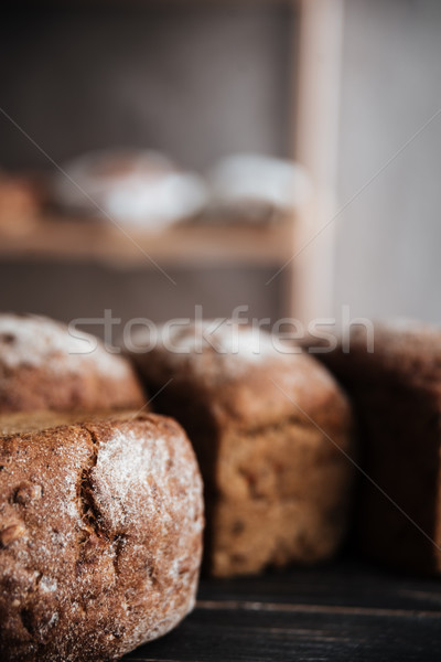 Bread with flour on dark wooden table Stock photo © deandrobot