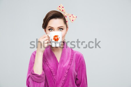 Serious woman standing isolated holding water gun and candy. Stock photo © deandrobot