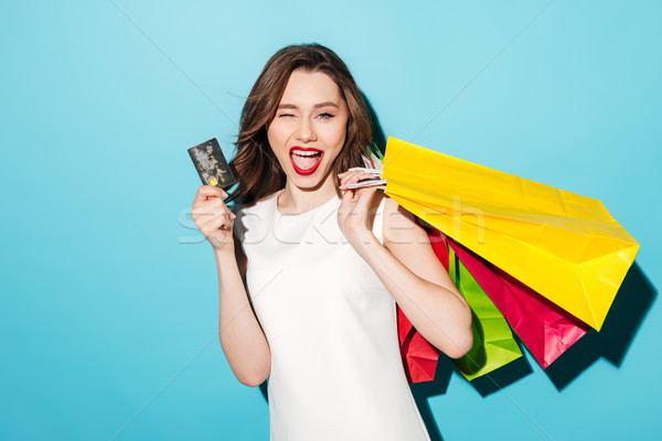 Girl in dress with shopping bags holding credit card Stock photo © deandrobot