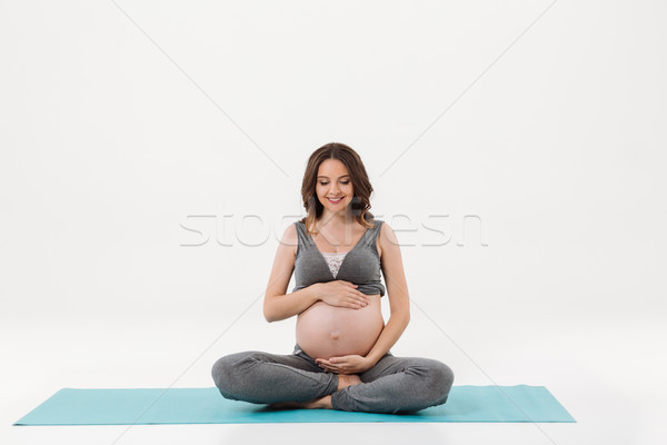 Mosolyog terhes nő ül fitnessz tart pocak Stock fotó © deandrobot