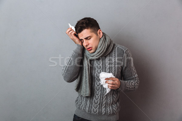 Sick Man in sweater and scarf with serviette Stock photo © deandrobot