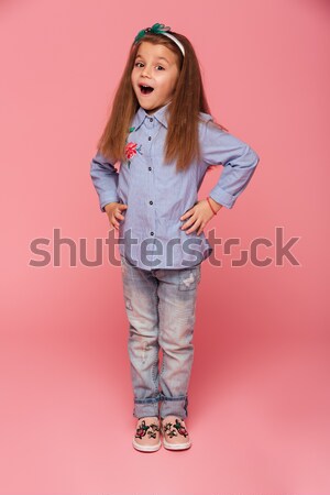 Full-length photo of adorable child girl with long auburn hair a Stock photo © deandrobot