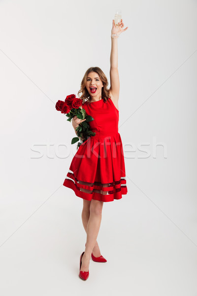 Full length portrait of a happy young woman Stock photo © deandrobot