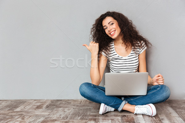 Nice woman with beautiful smile sitting in lotus pose on the flo Stock photo © deandrobot