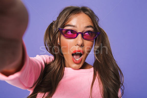 Stock photo: Portrait of a shocked young girl in sunglasses taking a selfie