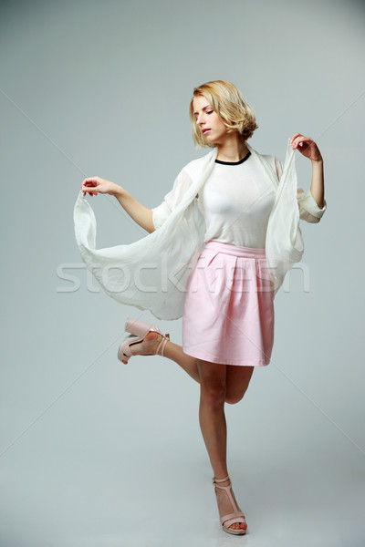 Young woman in light suit dancing with air Stock photo © deandrobot