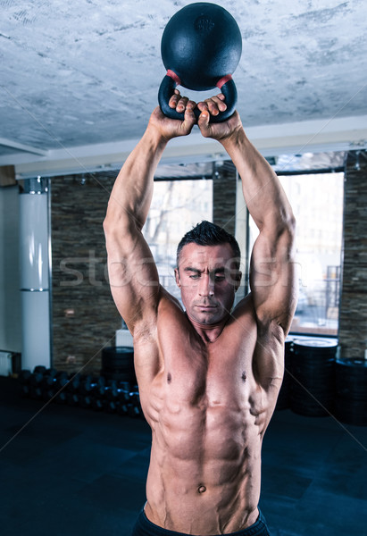 Testépítő férfi edzés bogrács labda crossfit Stock fotó © deandrobot