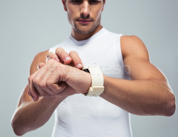 Fitness man using smartwatch Stock photo © deandrobot
