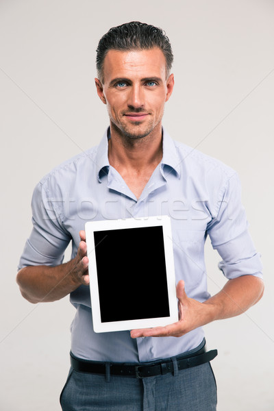 Businessman showing blank tablet computer screen Stock photo © deandrobot