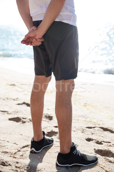 Gambe uomo pantaloncini piedi spiaggia Foto d'archivio © deandrobot