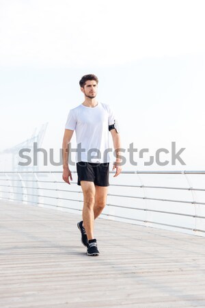 Man athlete running on wooden terrace Stock photo © deandrobot