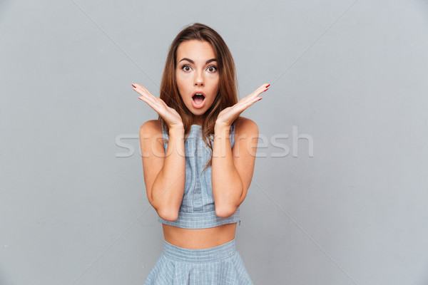 Surprised shocked young woman standing with opened mouth Stock photo © deandrobot