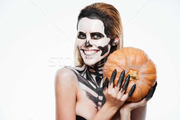 Happy woman with scared halloween makeup holding pumpkin and smiling Stock photo © deandrobot