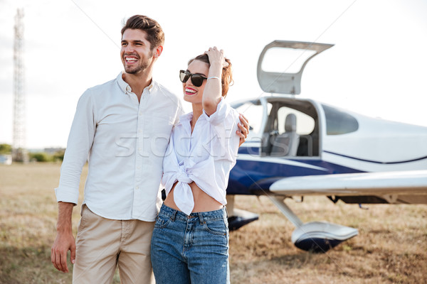 Couple standing in front of small private airplane Stock photo © deandrobot