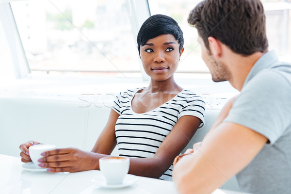 Happy couple drinking coffee and having good time in cafe Stock photo © deandrobot