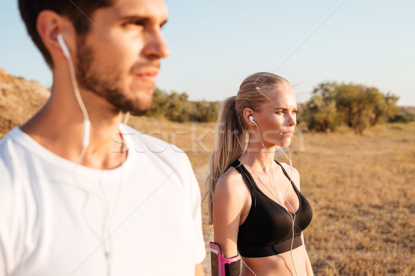 Fiatal fitnessz pár áll együtt fülhallgató Stock fotó © deandrobot