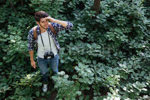 Homme perdu forêt shirt jumelles sac à dos [[stock_photo]] © deandrobot