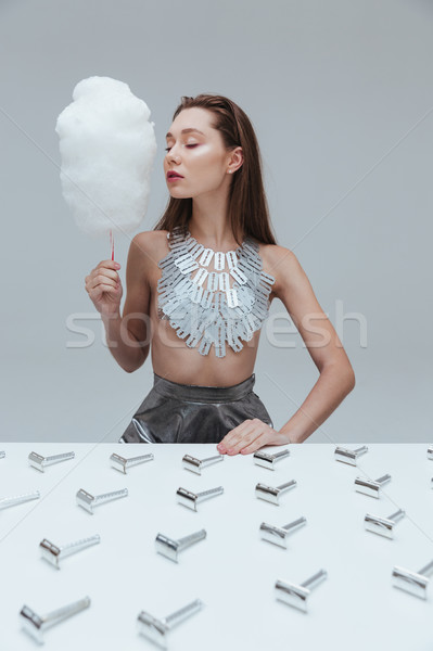 Stock photo: Sensual young woman with coton candy and vintage razor blades