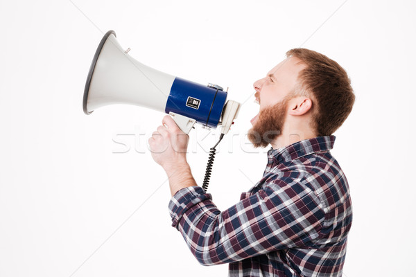 Jóvenes barbado hombre camisa gritando megáfono Foto stock © deandrobot