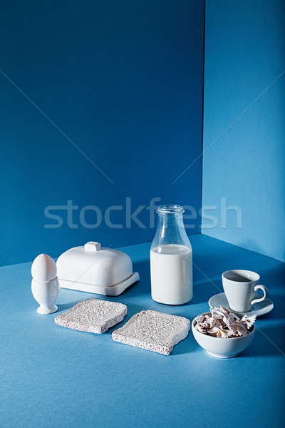 Milk bottle , bread slices, eggs, butter, cup and pasta bows Stock photo © deandrobot