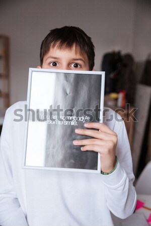 Girl holding poster with words You somebody reason to smile Stock photo © deandrobot