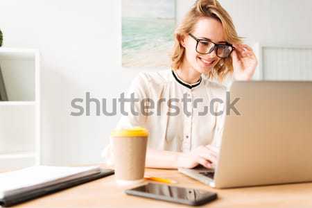 Young businesswoman in white shirt shocking when open a laptop Stock photo © deandrobot