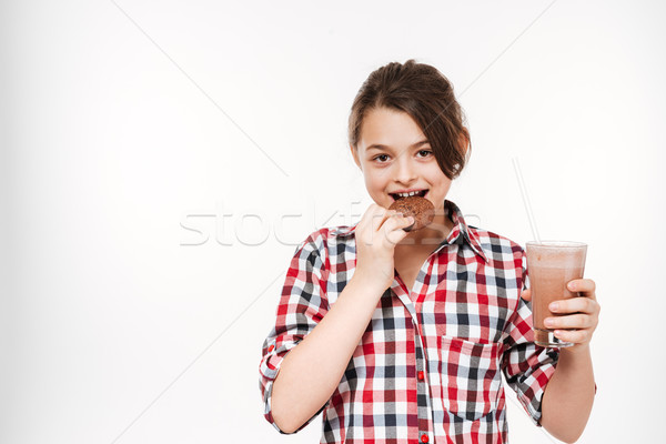 Cheerful young girl posing with cookie and cocoa Stock photo © deandrobot