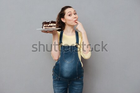 Portrait ravi jeunes femme enceinte manger gâteau au chocolat [[stock_photo]] © deandrobot