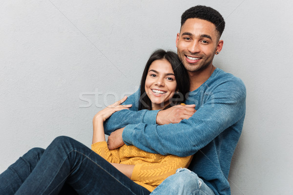 Lovers hugging and looking camera Stock photo © deandrobot