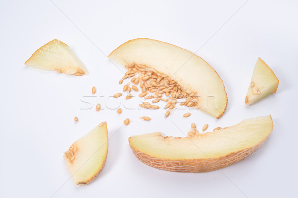 Slices of melon with stones in it Stock photo © deandrobot