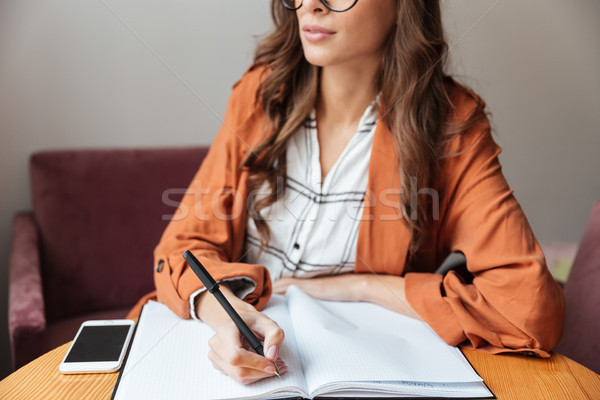 Cropped image of a young woman Stock photo © deandrobot