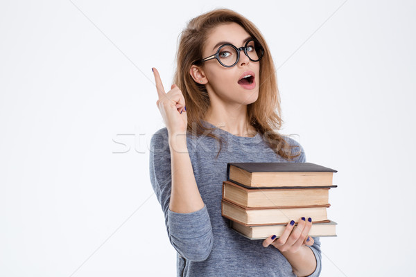 Mujer libros senalando dedo hasta Foto stock © deandrobot
