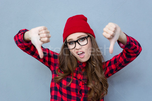 Woman showing thumbs down gesture Stock photo © deandrobot