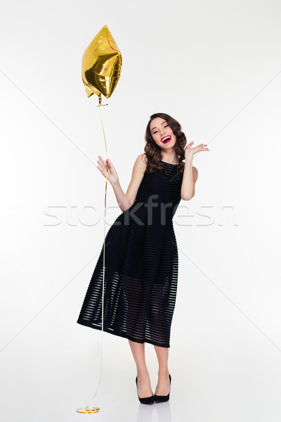 Cheerful woman with makeup in retro style holding golden balloon  Stock photo © deandrobot
