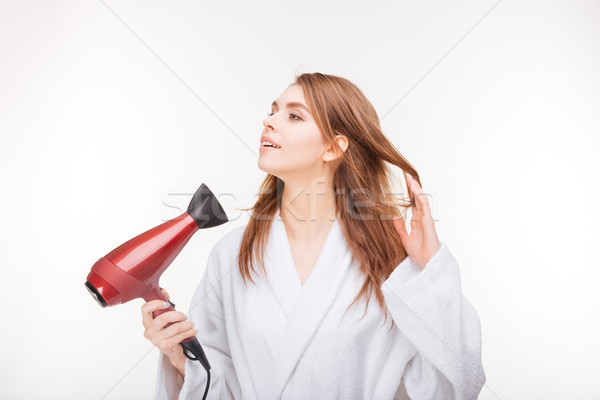 Güzel gülen genç kadın bornoz saç kurutma makinesi beyaz Stok fotoğraf © deandrobot