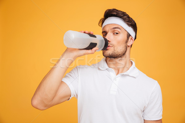 Porträt Fitness Mann Trinkwasser isoliert jungen Stock foto © deandrobot