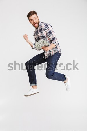 Casual handsome man dancing over white background Stock photo © deandrobot