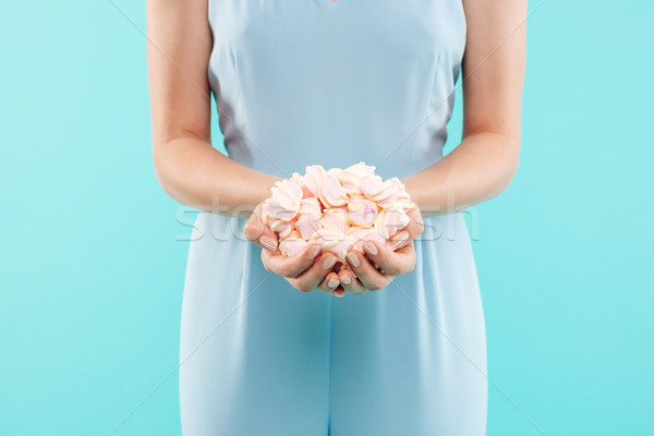 Hands of young woman holding marshmallows Stock photo © deandrobot