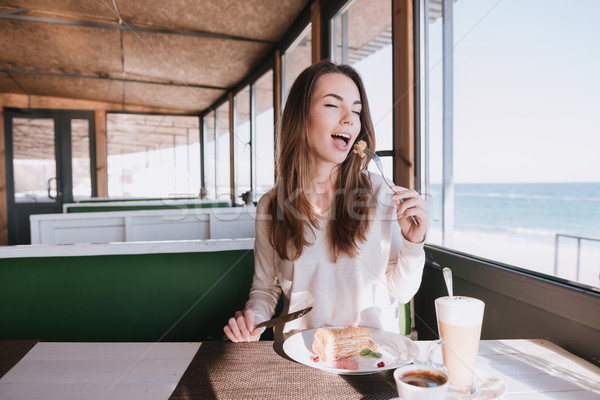 Woman eating on date with coffee and cake in cafe Stock photo © deandrobot