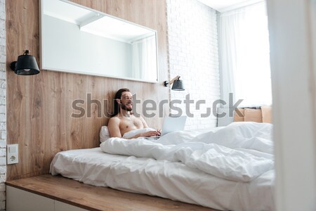 Young woman lying on bed Stock photo © deandrobot