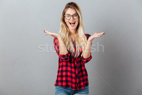 Emotional surprised young blonde woman Stock photo © deandrobot