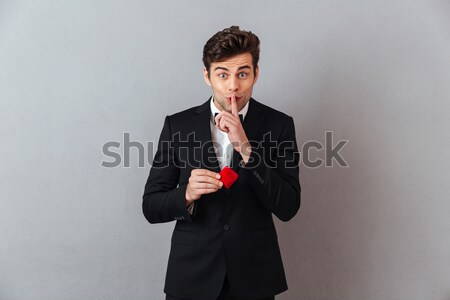 Handsome man in official suit holding box with proposal ring Stock photo © deandrobot