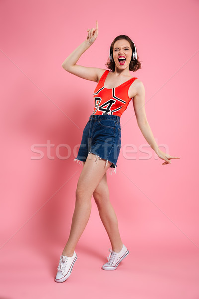 Stock photo: Excited amazing young lady dancing isolated