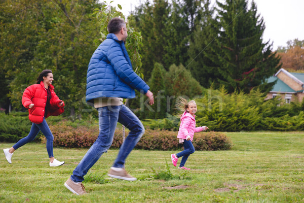 Beautiful young family having fun together at the park Stock photo © deandrobot