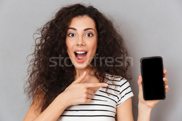 Close up photo of optimistic woman with ring in nose pointing in Stock photo © deandrobot