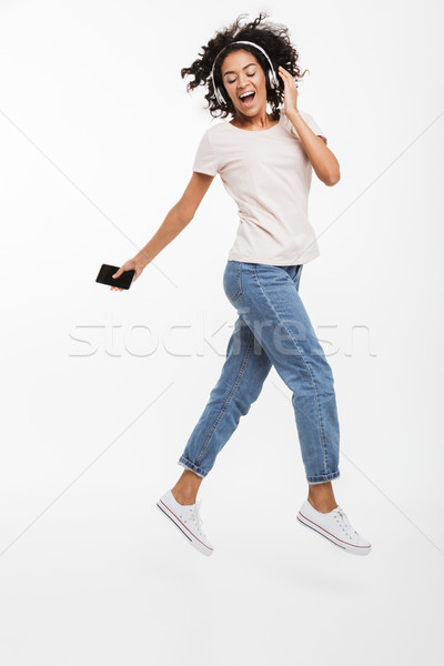 Full length image of satisfied african american woman taking ple Stock photo © deandrobot