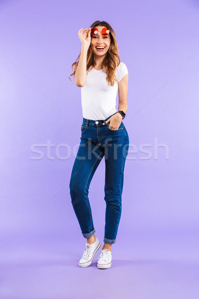 Full length portrait of a smiling young girl in sunglasses Stock photo © deandrobot