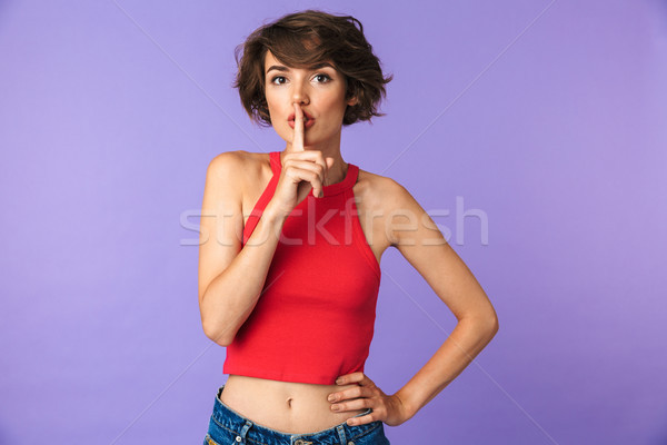 Portrait of a lovely young girl showing silence gesture Stock photo © deandrobot